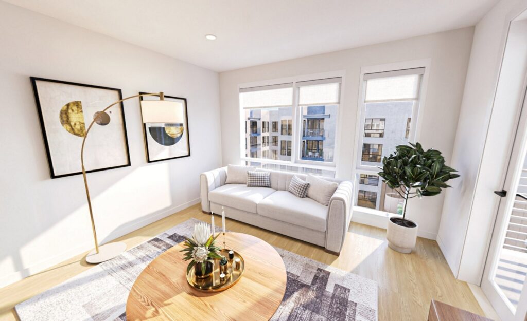 Mountain View, CA, Pet-Friendly Luxury Apartments - Avelle - Bright Living Room with Modern Wood-Plank Flooring, Area Rug, Grey Sofa, Round Wooden Coffee Table, Standing Lamp, Potted Plant, Expansive Windows, and Glass Door with Access to Balcony.